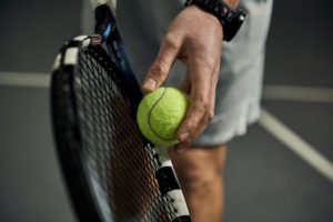 Man about to serve a tennis ball