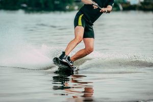 Male wakeboard rider on a lake in summer.