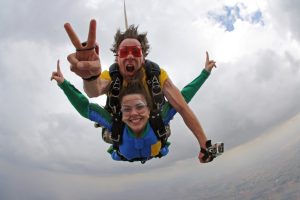 two adults doing sky diving