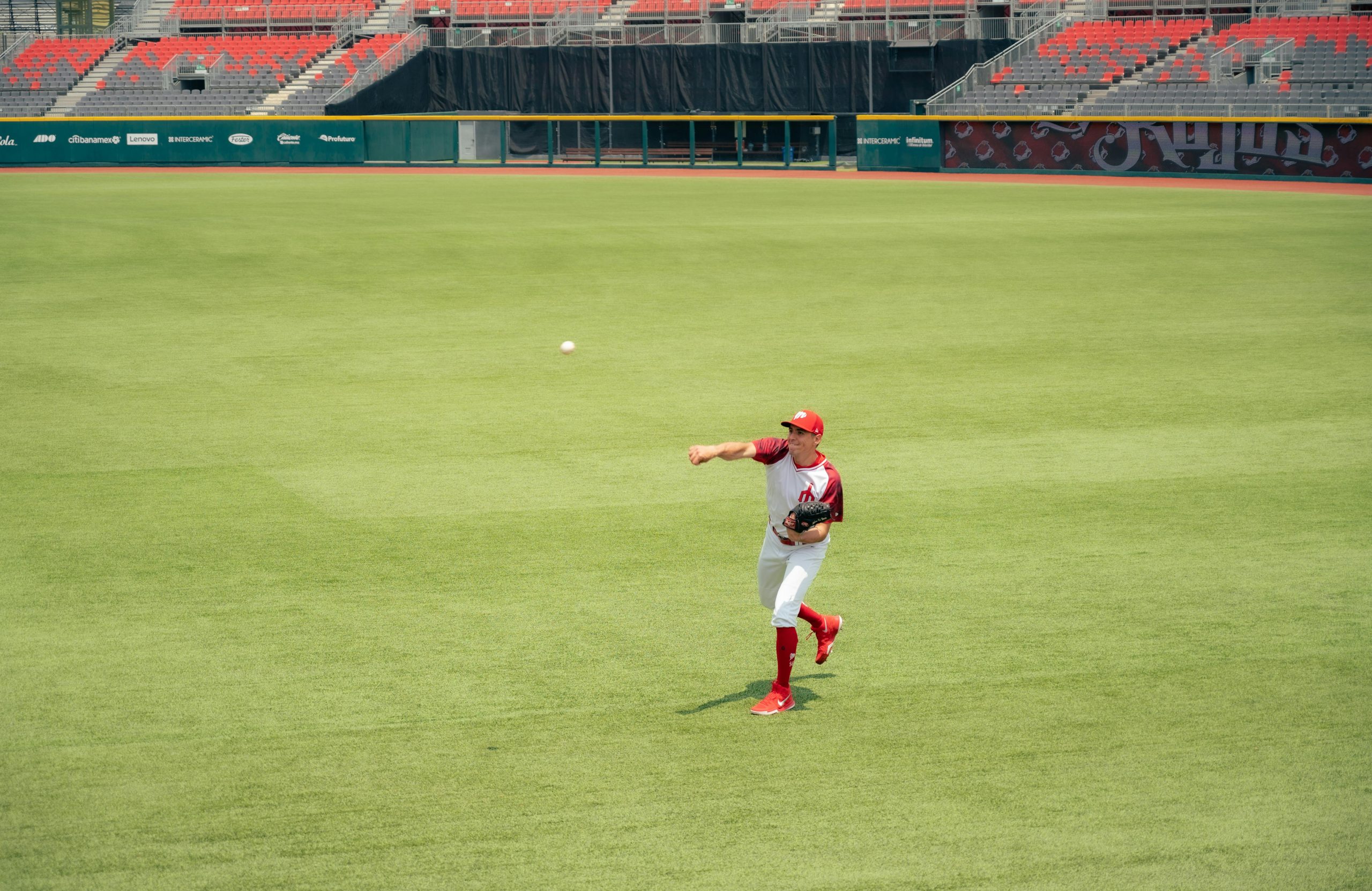 pitcher on the field with the ball in midair